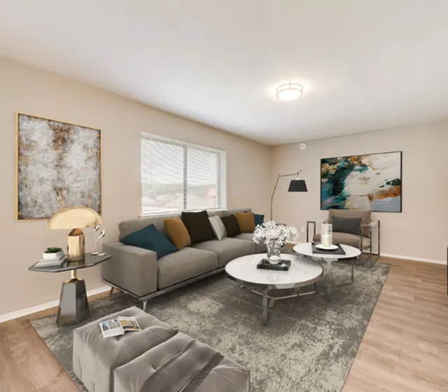 Modern living room with stylish decor, featuring a cozy sofa, elegant coffee table, and chic artwork, illuminated by natural light through a large window.
