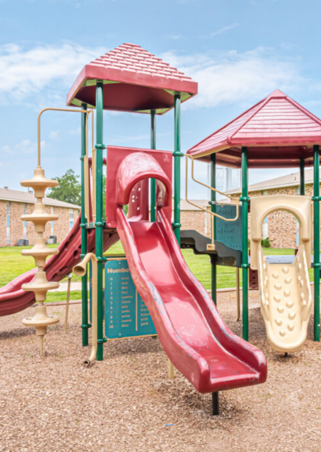 Inviting playground featuring slides and climbing structures, perfect for family fun and outdoor activities.