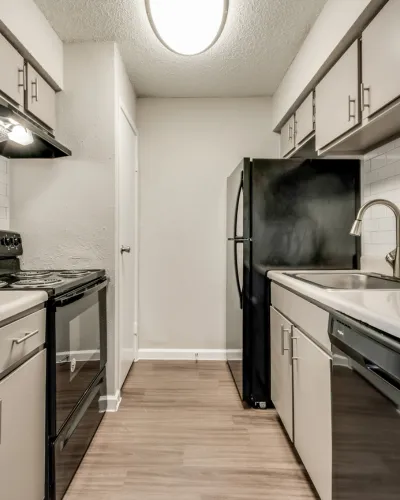 Modern galley kitchen boasting sleek appliances, ample cabinetry, and elegant countertops.