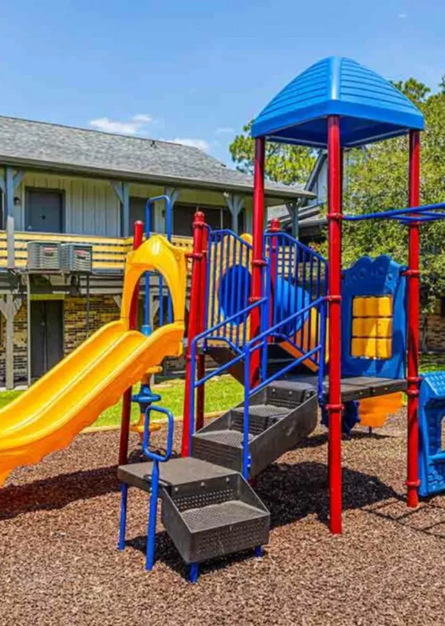 Vibrant children's playground with colorful slides and climbing structures, perfect for family fun in a sunny, outdoor community space.