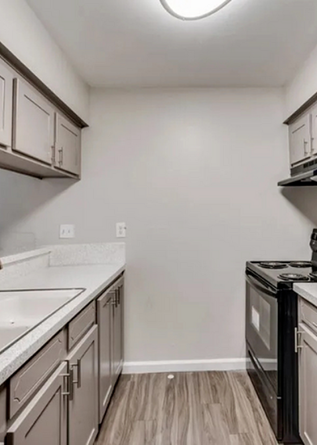Modern kitchen with sleek cabinetry, elegant countertops, and stylish appliances in a cozy layout.