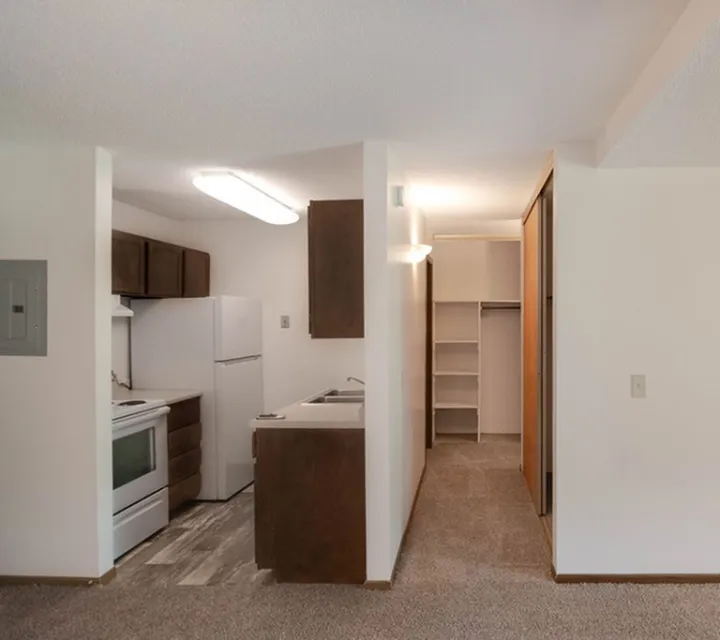 Cozy apartment kitchen with modern appliances, ample cabinet space, and a convenient pantry closet.