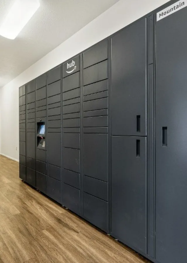 Modern package locker system with sleek black design, perfect for secure parcel delivery in stylish apartment complex.