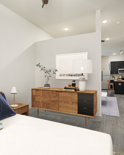 Modern apartment with sleek wooden furniture, open layout, and bright lighting leading to a stylish kitchen.