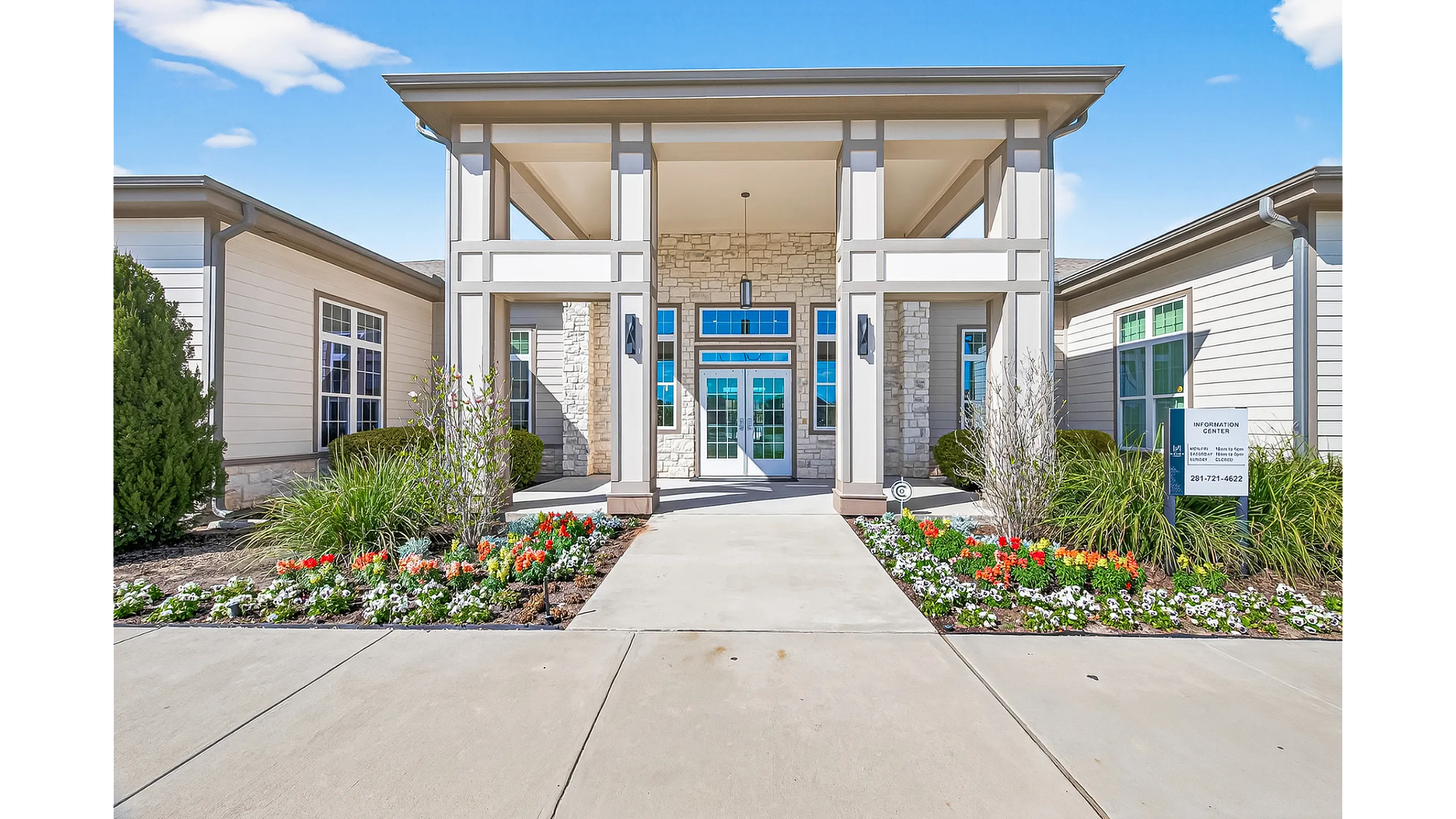 Elegant apartment building entrance with grand pillars, inviting pathway, and vibrant landscaped garden.