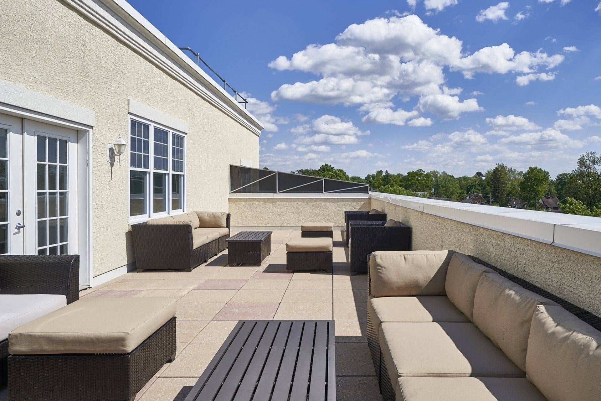Ardmore PA Apartments - The Athens - Rooftop Terrace with Lounge Seating, Tables, and City View