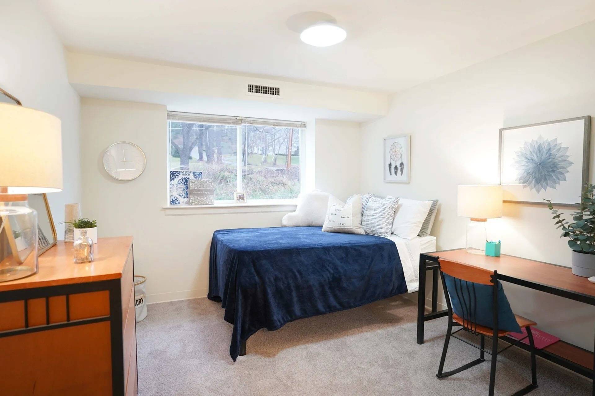 Apartments For Rent In Mansfield, PA - Commons At Mansfield - Spacious Bedroom With Plush Carpet Flooring, A Window, And Bedroom Furniture.