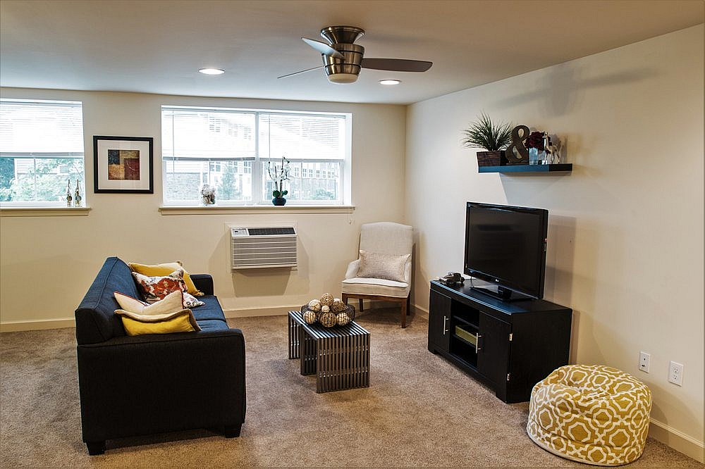 Chic living room with modern furniture, large windows, and stylish decor accents.
