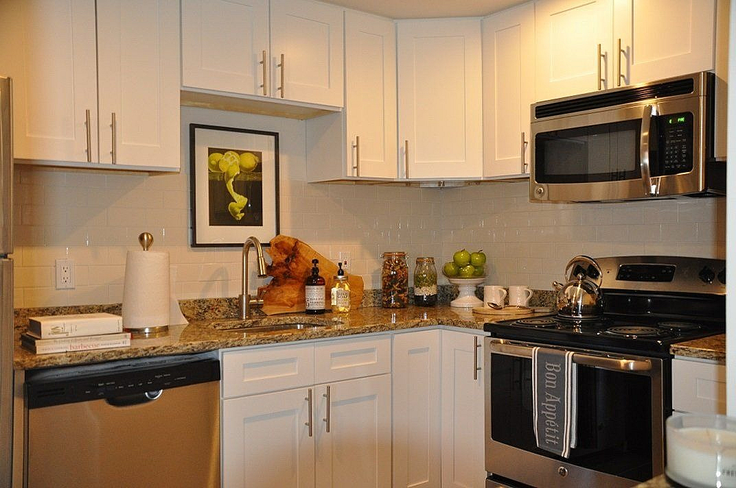 Chic and modern kitchen with stainless steel appliances, granite countertops, and elegant cabinetry, offering a stylish cooking space.