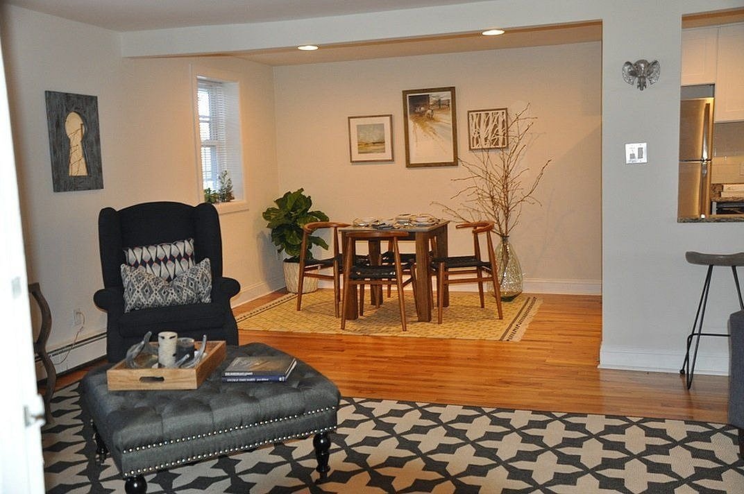 Charming living and dining area with cozy seating, elegant decor, and warm wooden floors, perfect for stylish entertaining.