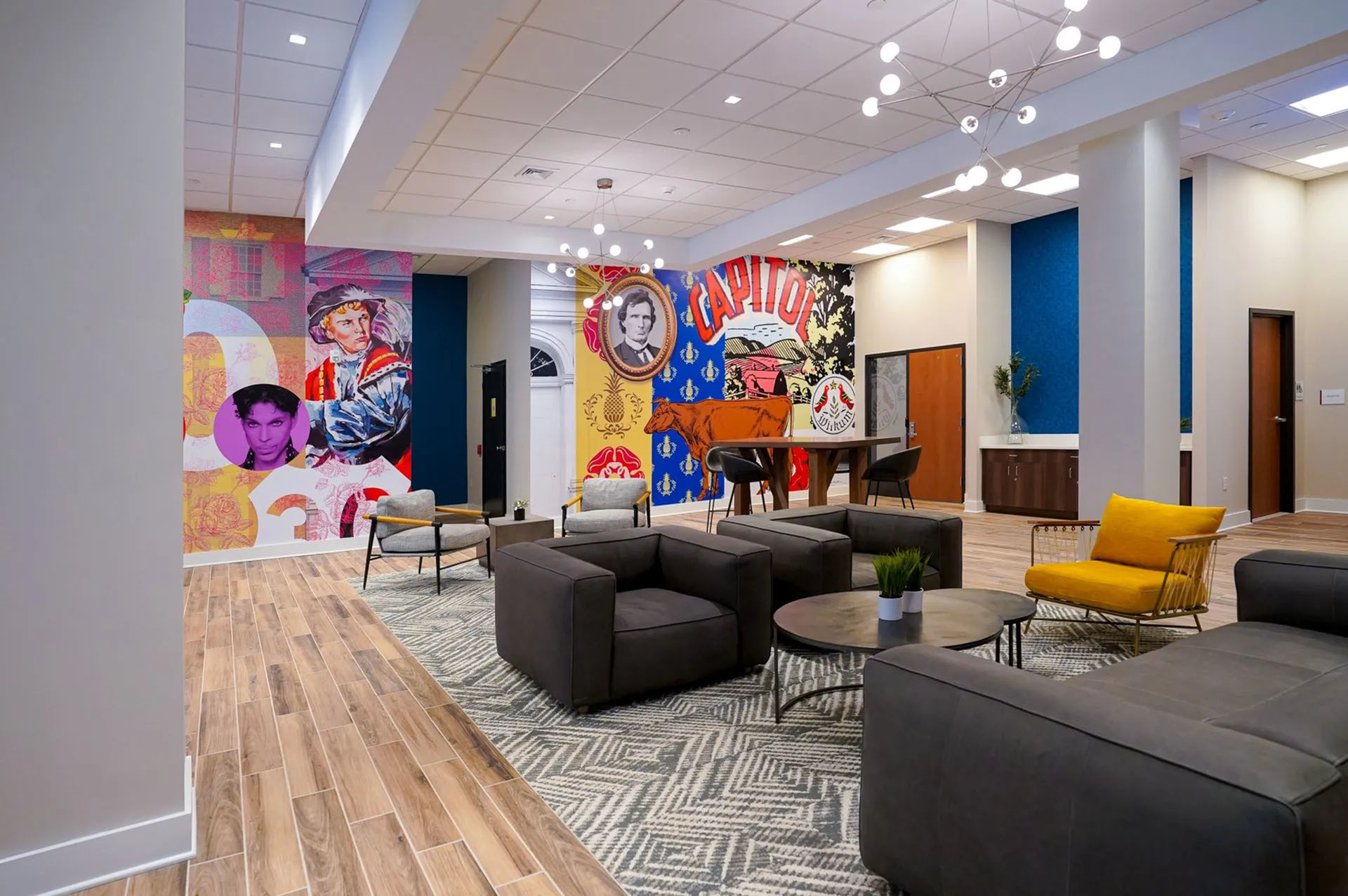 Vibrant lobby with colorful murals, modern seating, and a chic ambiance, perfect for relaxation and social gatherings.
