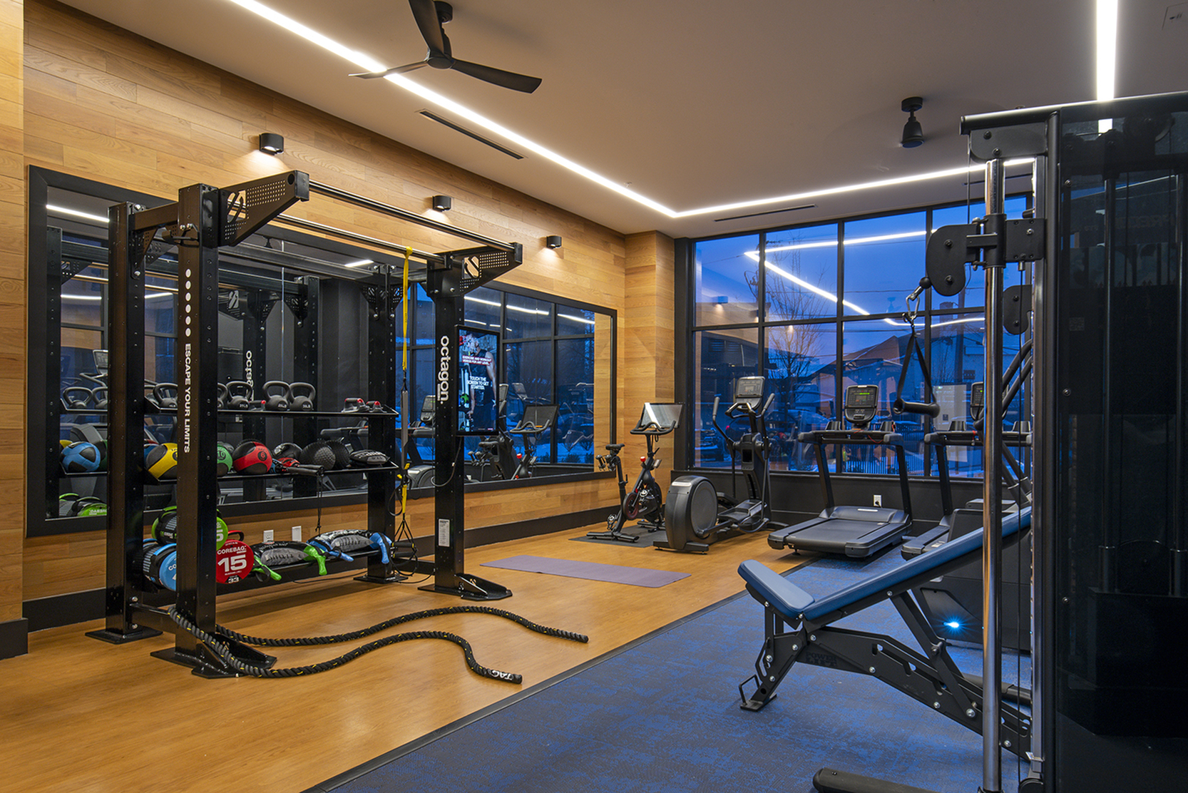 Modern fitness center equipped with state-of-the-art exercise machines, vibrant weights area, and a spacious workout environment.
