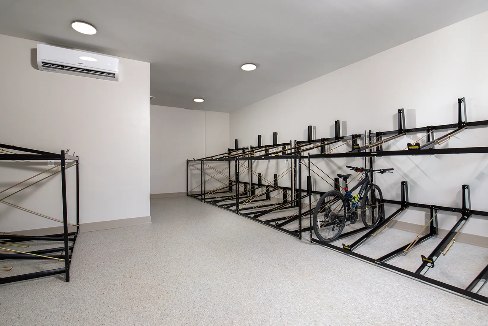 Secure and modern bike storage room with ample racks and efficient lighting, perfect for urban living.