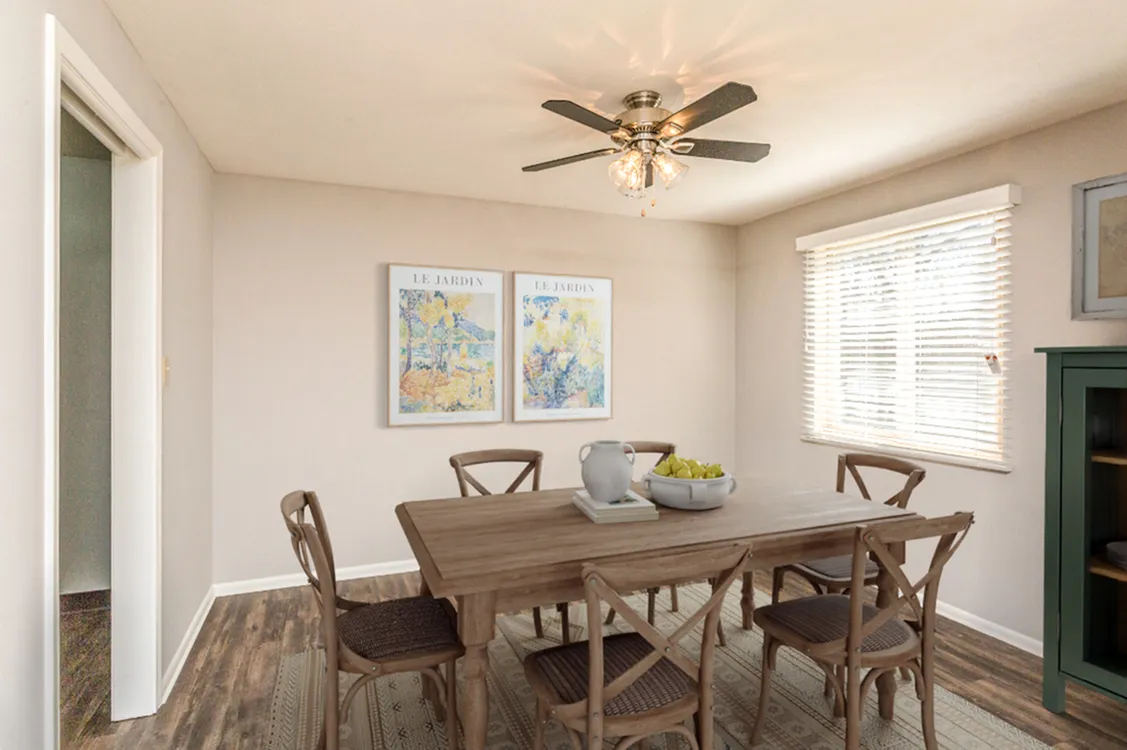 Charming dining room with elegant wooden table, stylish chairs, and natural light streaming through large windows.