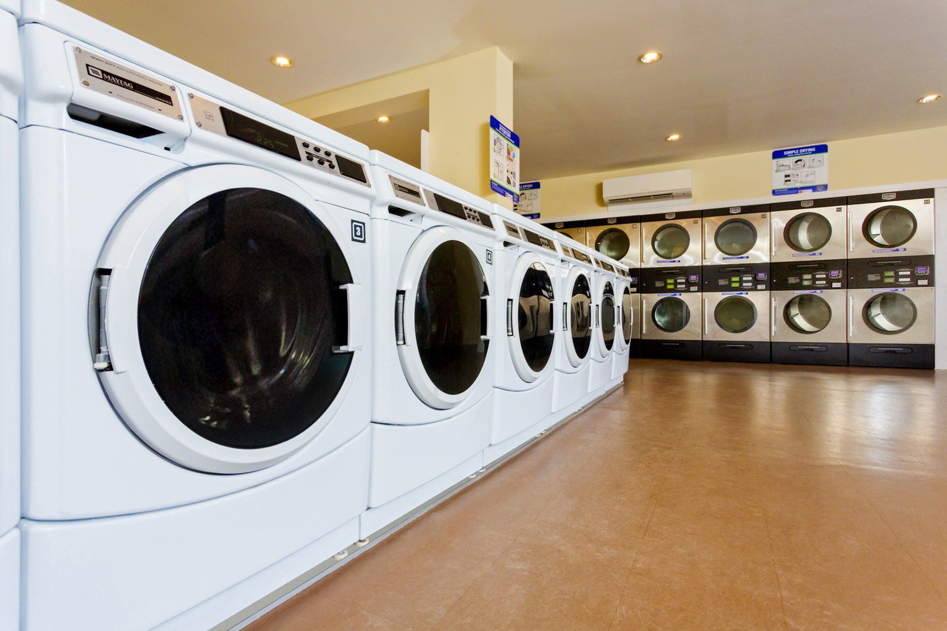 Modern laundry facility featuring an array of state-of-the-art washing machines, providing convenience and efficiency for residents.
