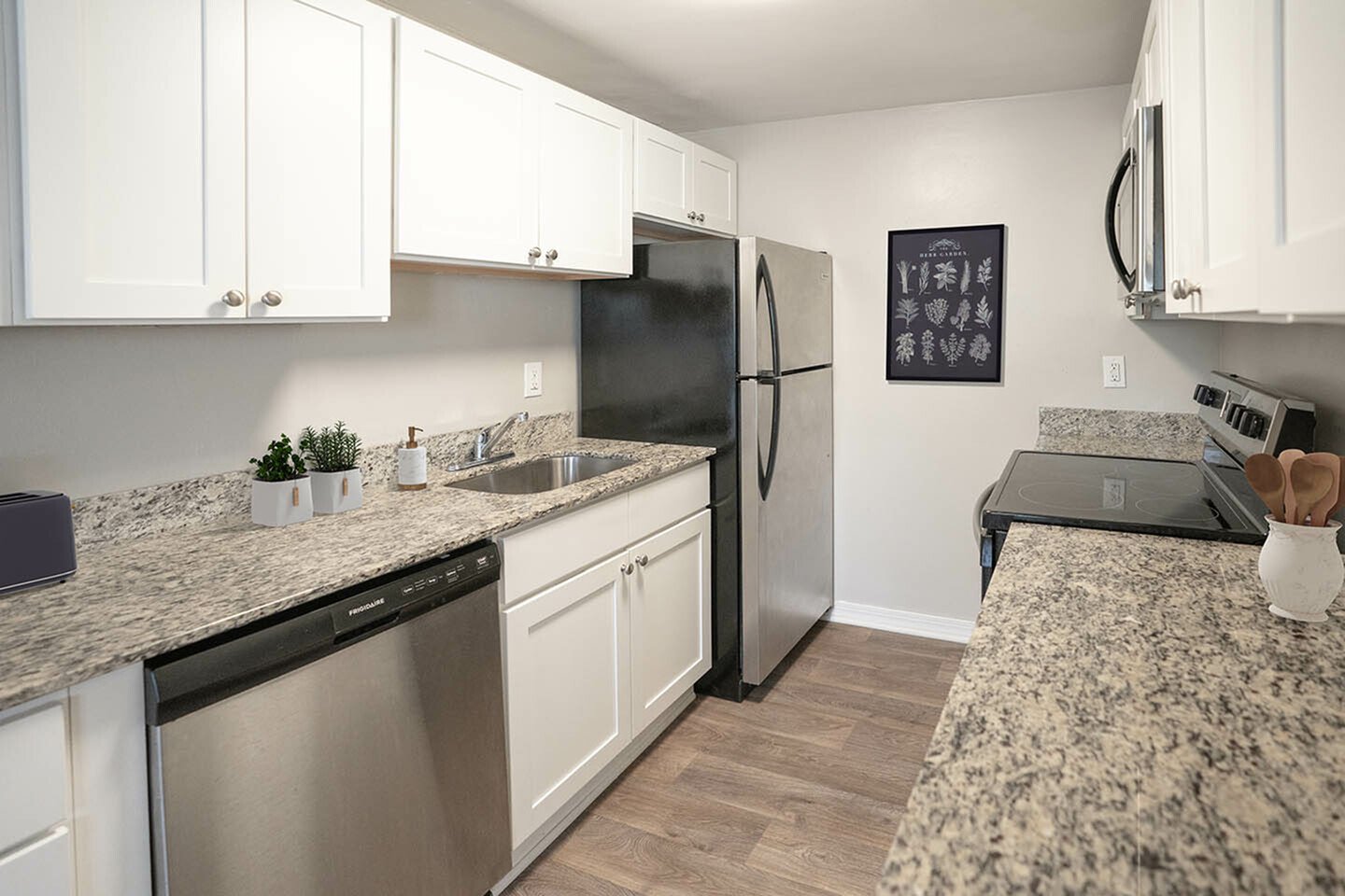 Modern kitchen with sleek granite countertops, white cabinetry, and stainless steel appliances for a contemporary feel.