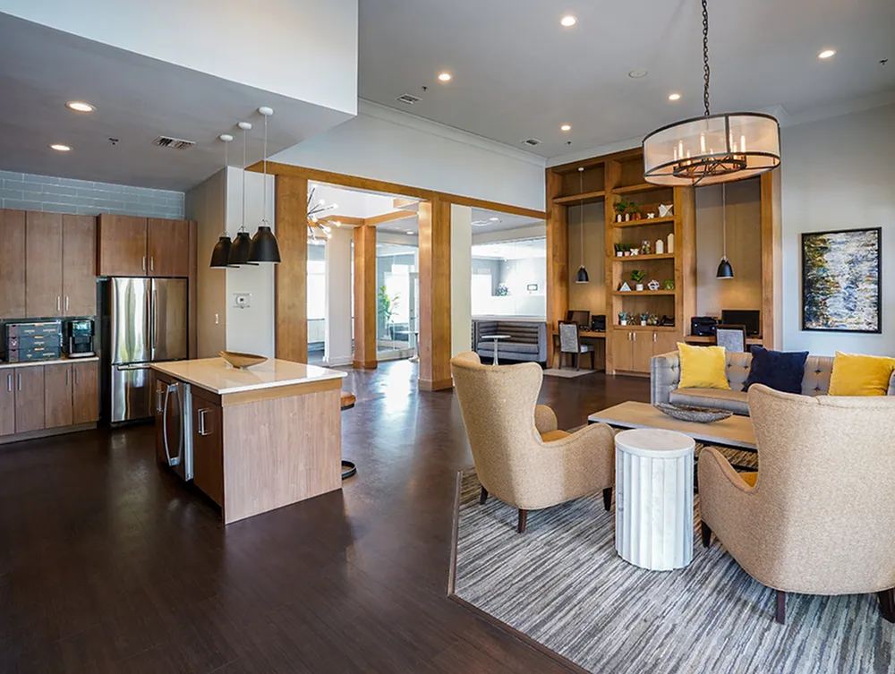 Modern open-concept living space featuring a stylish kitchen with stainless steel appliances, elegant seating area, and cozy decor.