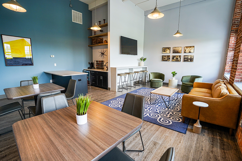 Modern communal lounge featuring stylish furniture, vibrant artwork, and natural light for a welcoming ambiance.
