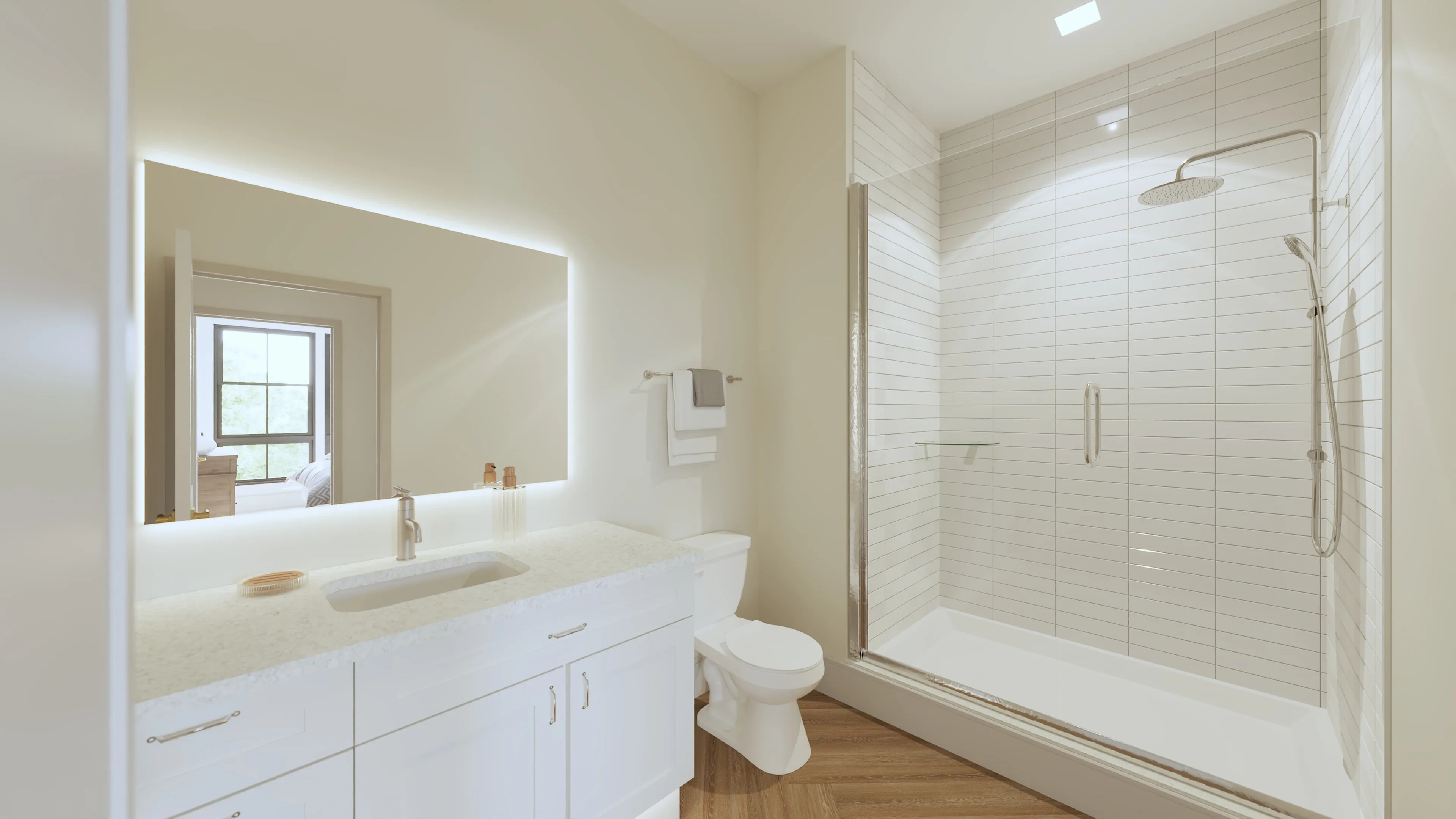 Elegant bathroom featuring a sleek glass shower, modern fixtures, and a large illuminated mirror complemented by warm wood flooring.