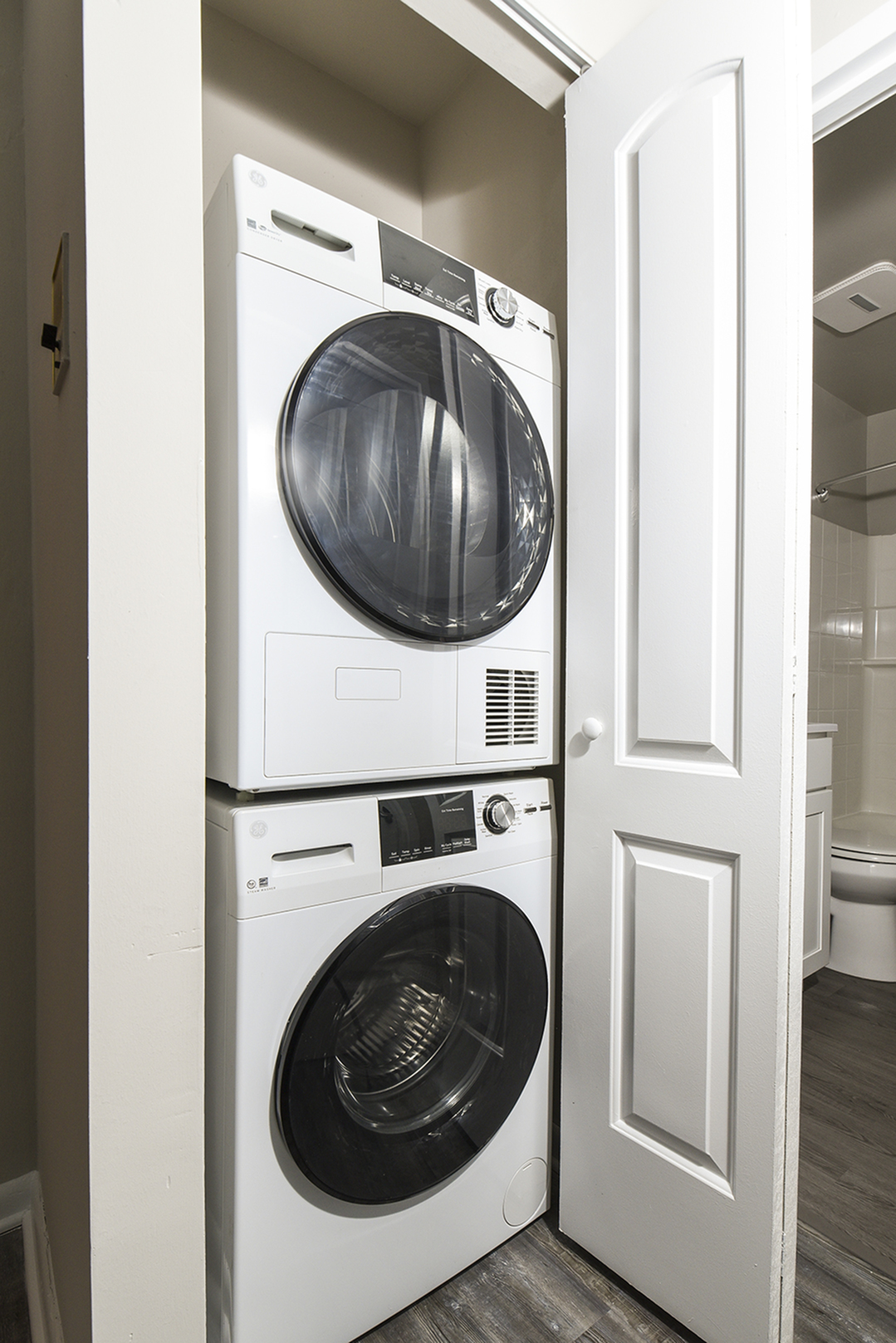 Compact laundry area featuring a modern stackable washer and dryer in a sleek white design, perfect for maximizing space.