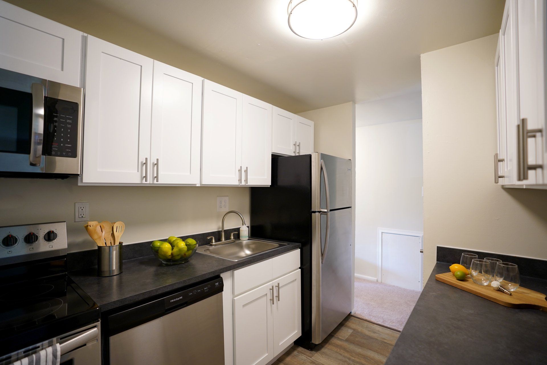 Modern kitchen with sleek stainless steel appliances, elegant white cabinetry, and stylish countertops, designed for culinary inspiration.