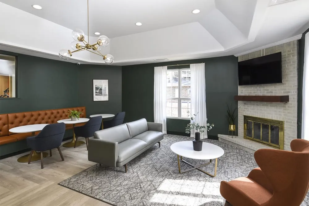 Chic living room featuring modern seating, elegant lighting, and a cozy fireplace, perfect for relaxation and entertaining.