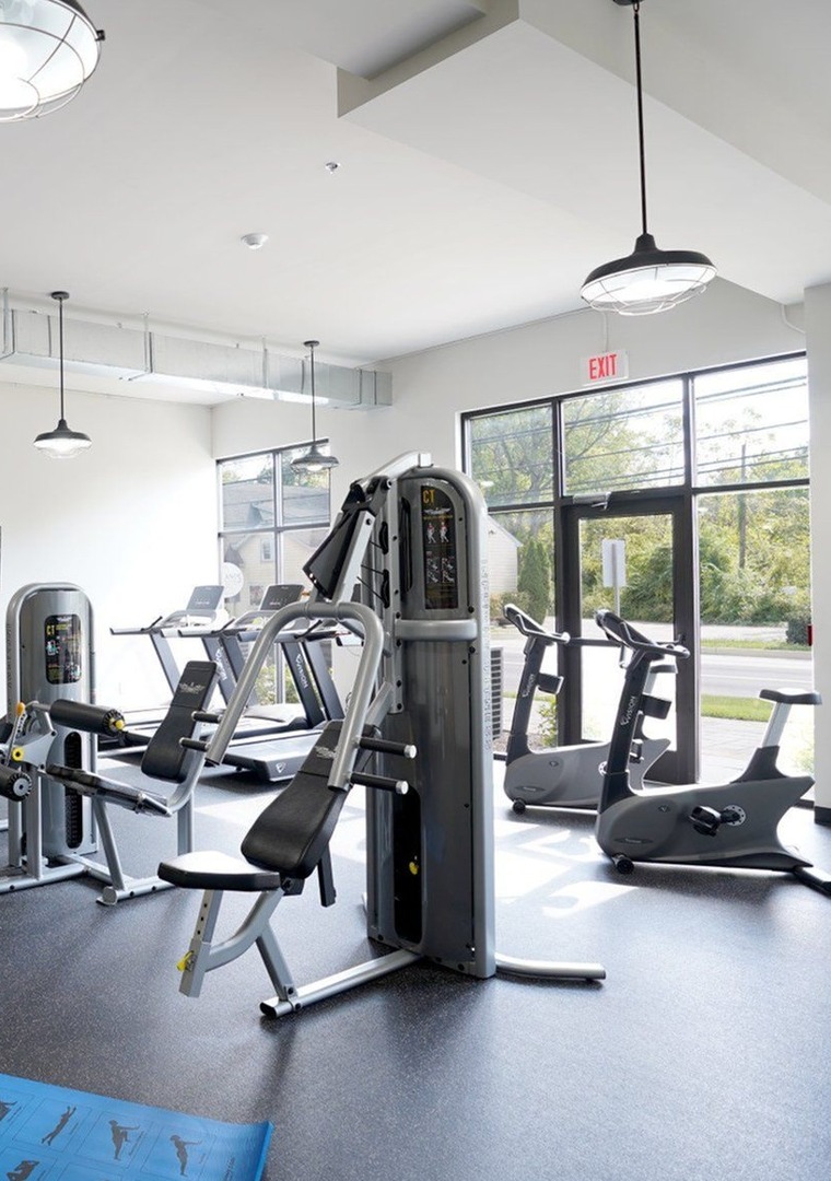 Fitness Center with cardio and strength training equipment, large windows
