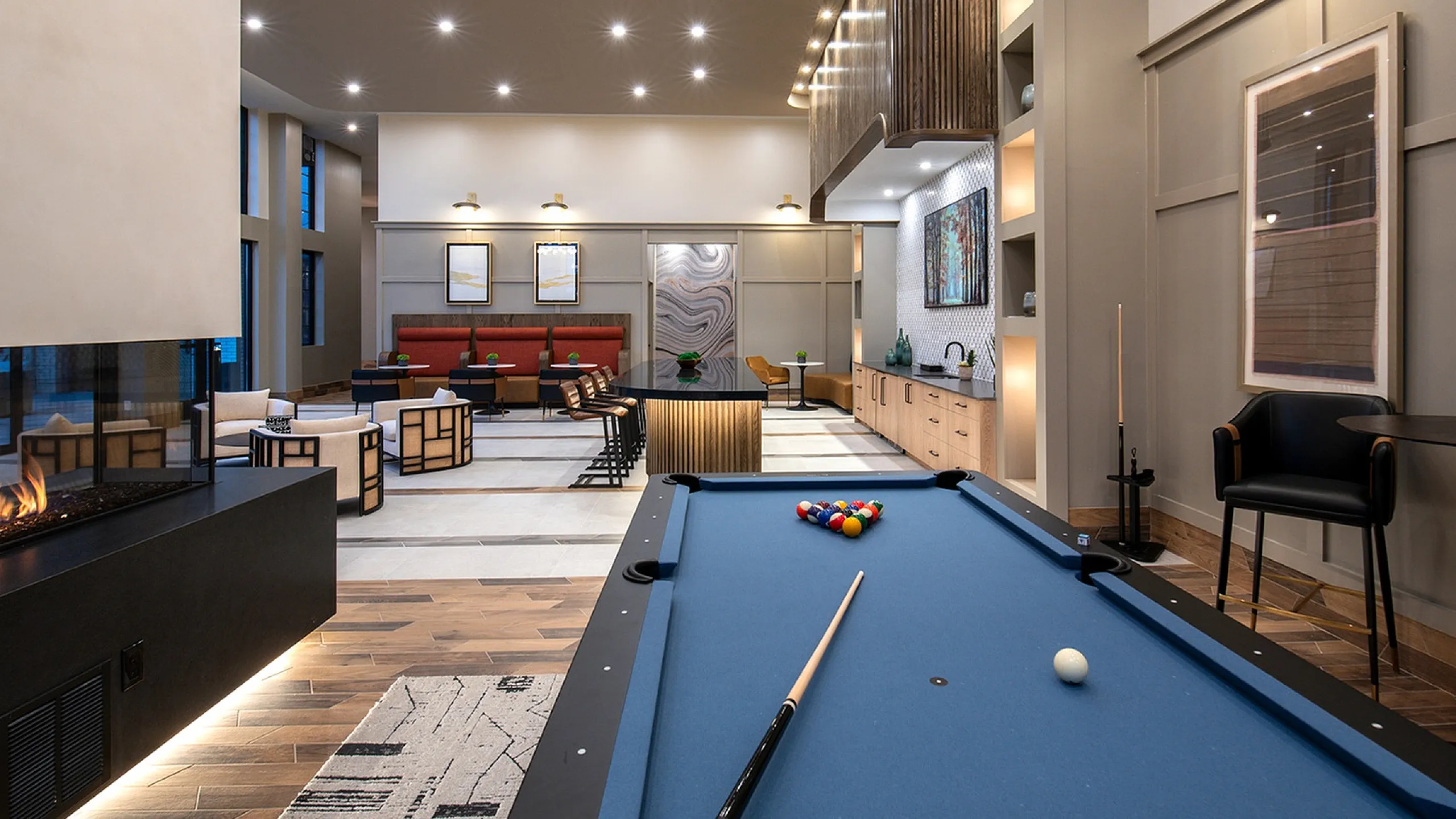 Chic lounge with pool table, modern seating, and ambient lighting.