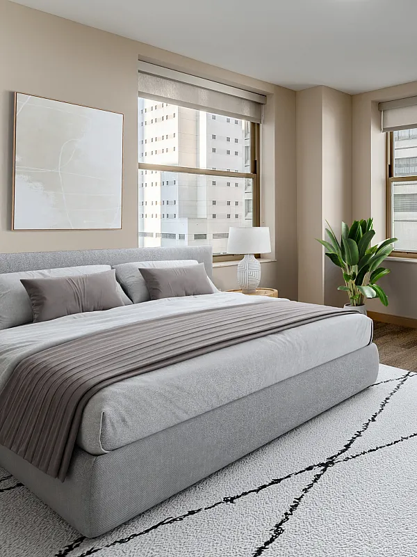 Luxurious bedroom with a large bed, stylish furnishings, and expansive city views.