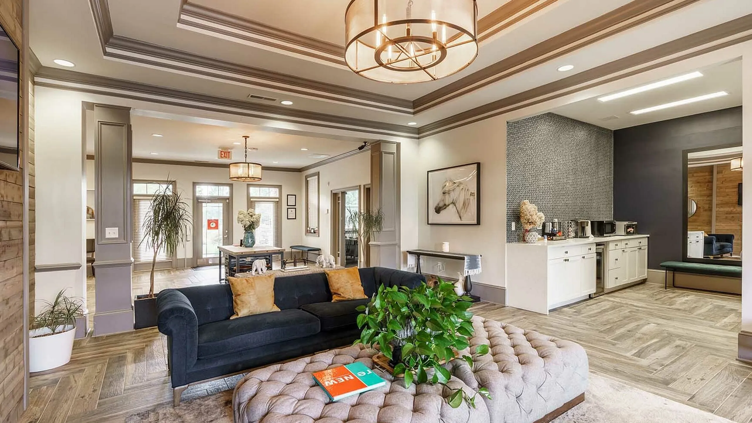 Elegant living room with chic decor, featuring a plush sofa, modern lighting fixtures, and a cozy sitting area.