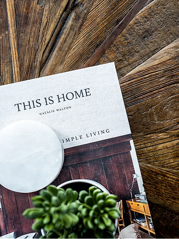 Chic coffee table adorned with a stylish book, 'This Is Home,' ideal for cozy and elegant living spaces.