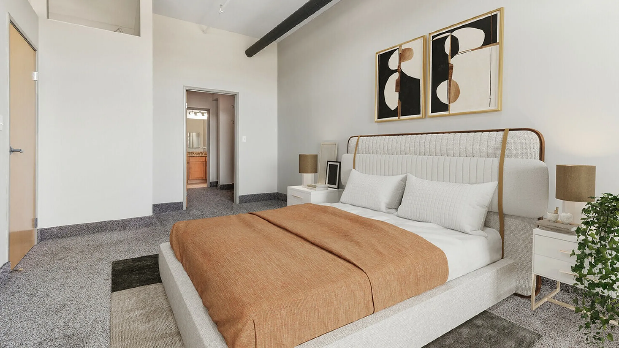 Modern bedroom with elegant decor, featuring a comfortable bed, stylish artwork, and cozy lighting in a spacious setting.
