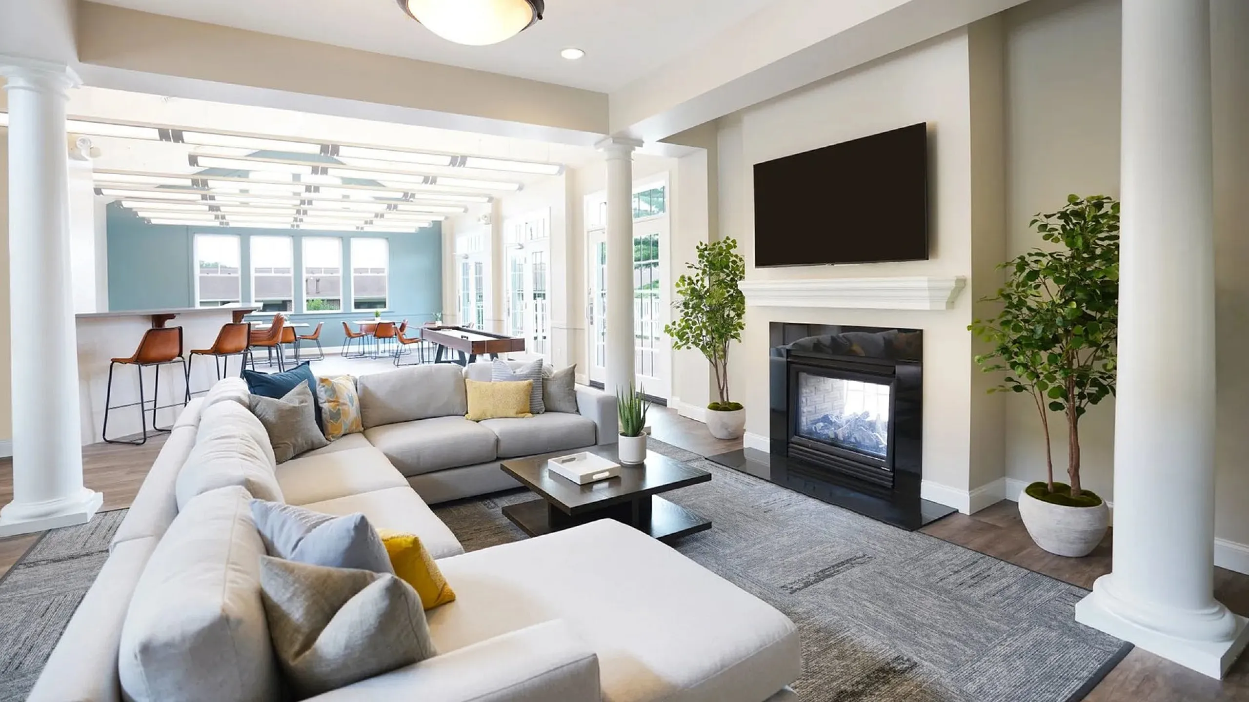 Spacious and elegant living room with plush seating, modern decor, and a cozy fireplace, perfect for relaxation and entertainment.