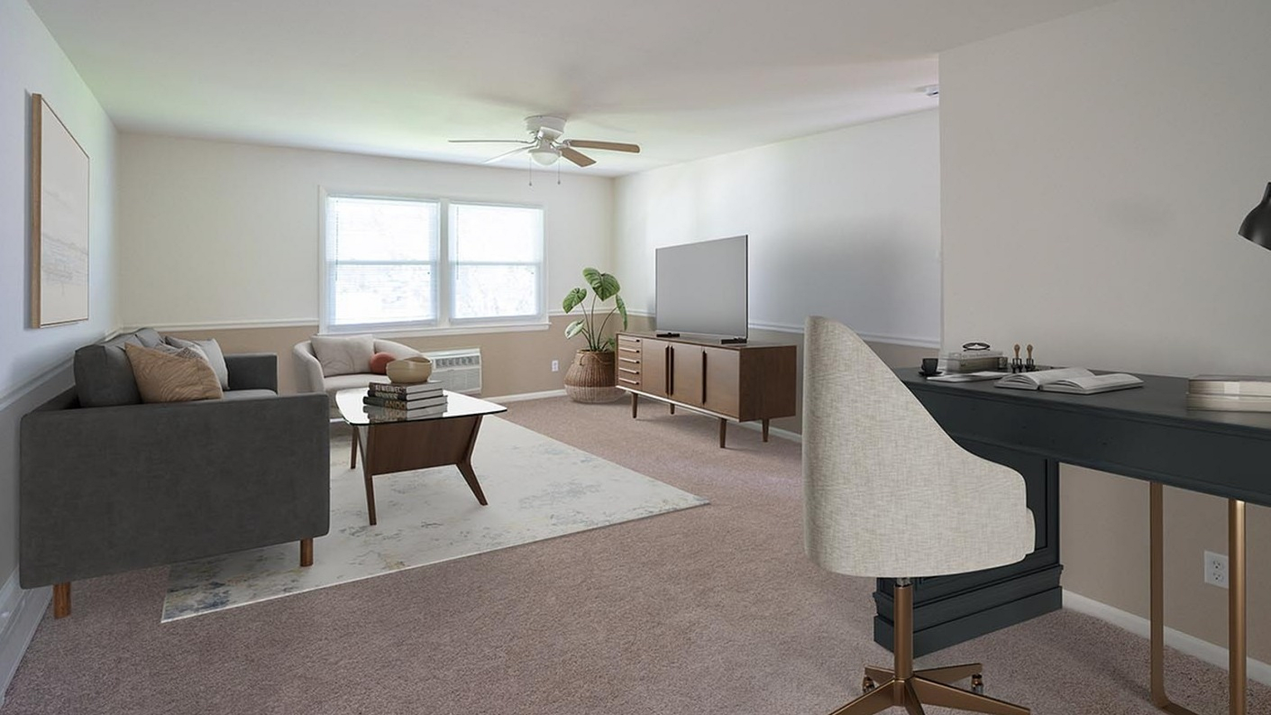 Bright, inviting living room with modern furniture, plush carpet, and a sleek desk space.