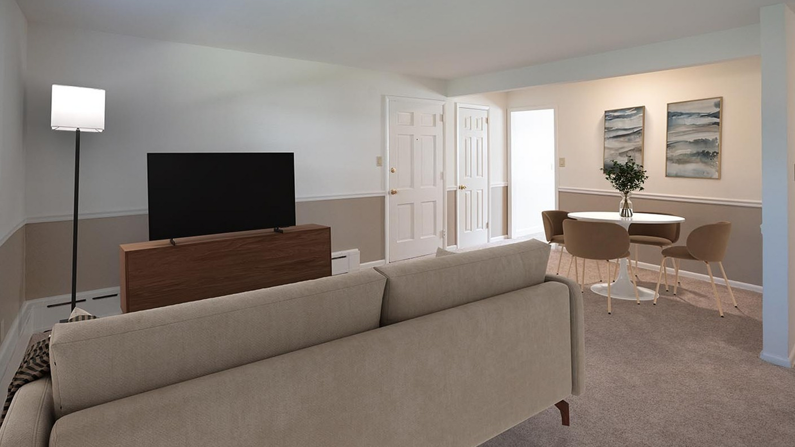Elegant living room with cozy sofa, sleek TV stand, modern dining area, and tasteful artwork.