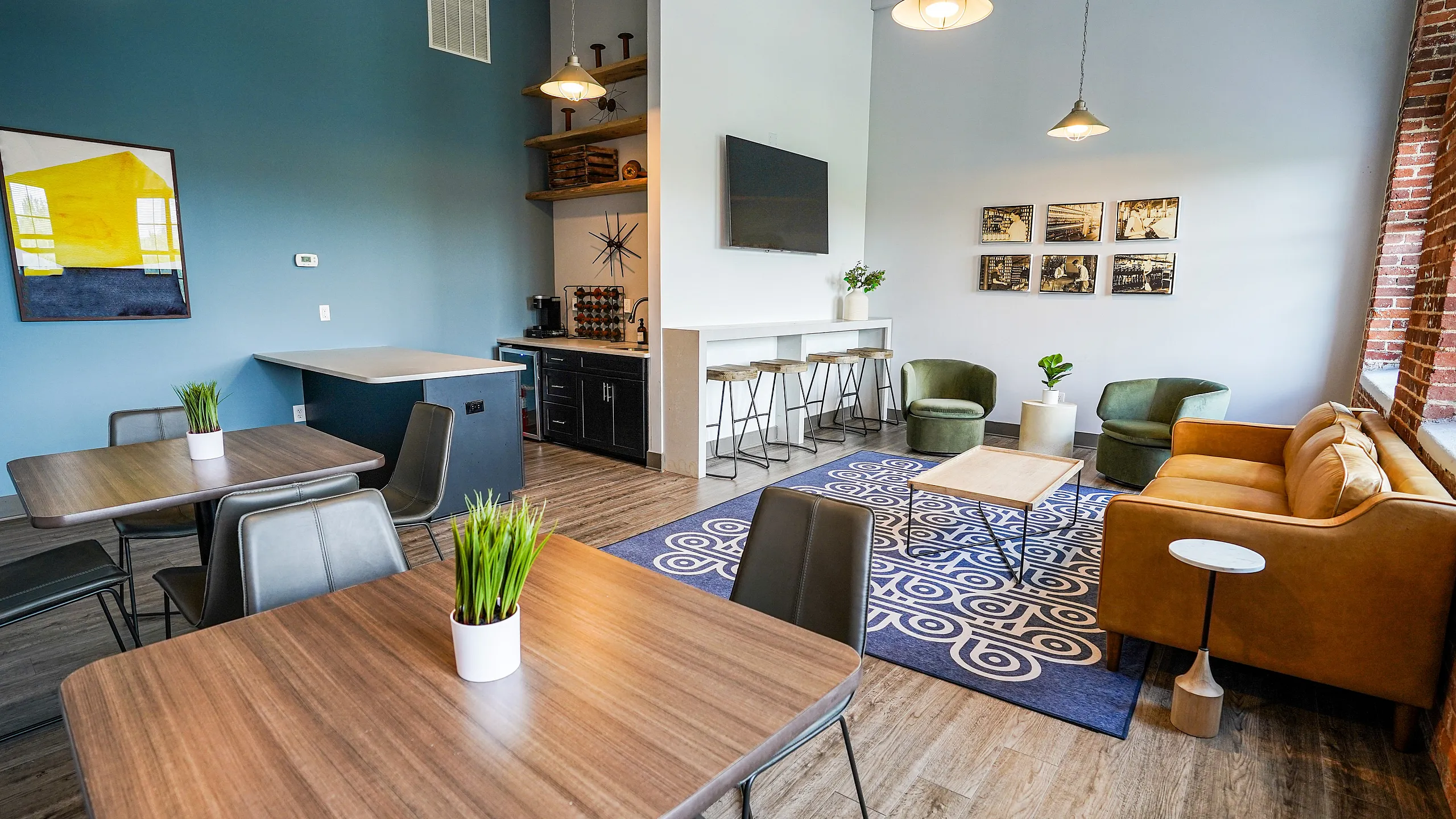 Chic apartment common area with modern furniture, vibrant blue accent wall, and contemporary decor.