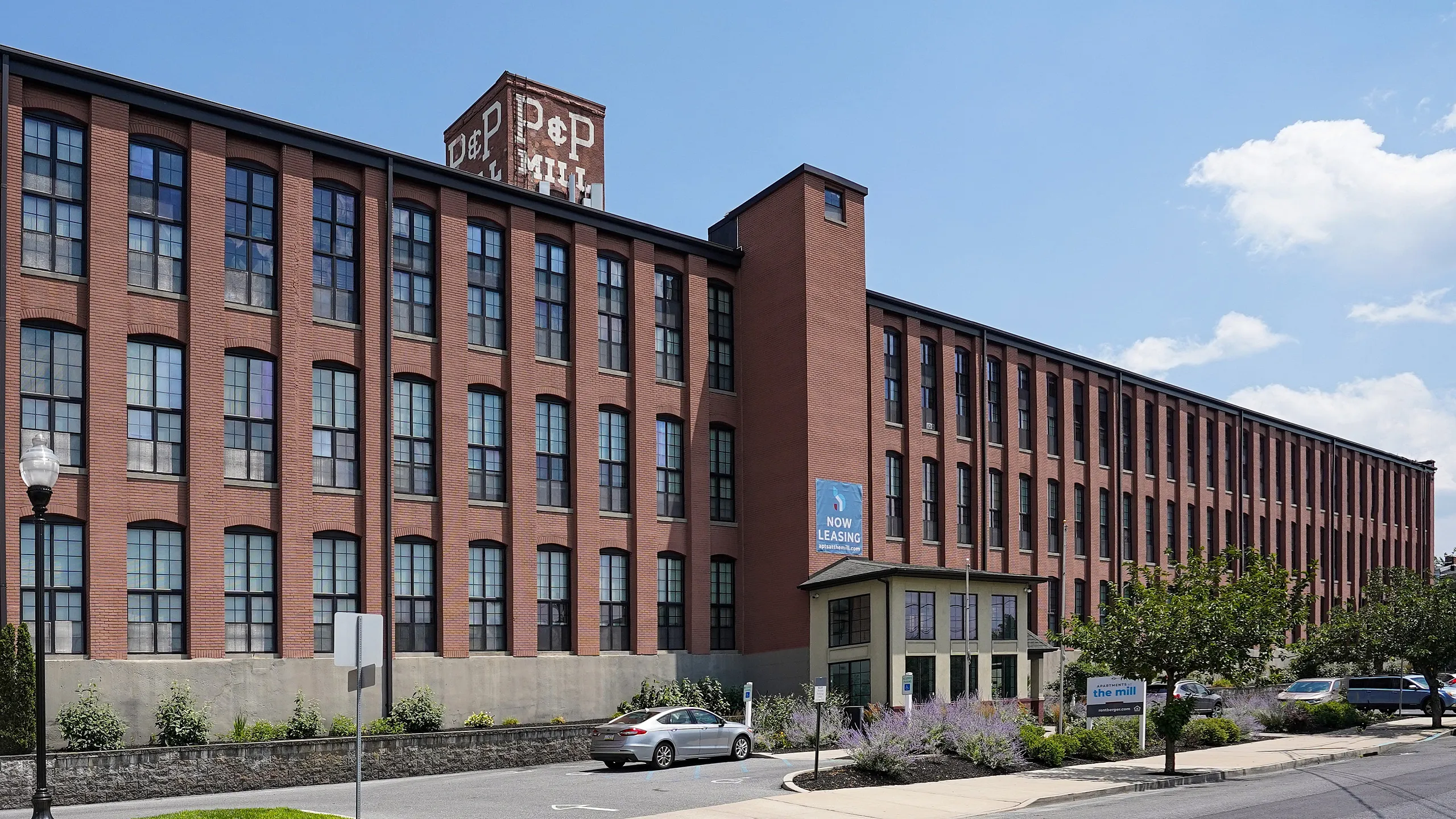 Impressive brick architecture of a historic building now leasing modern apartments, blending classic design with contemporary living.