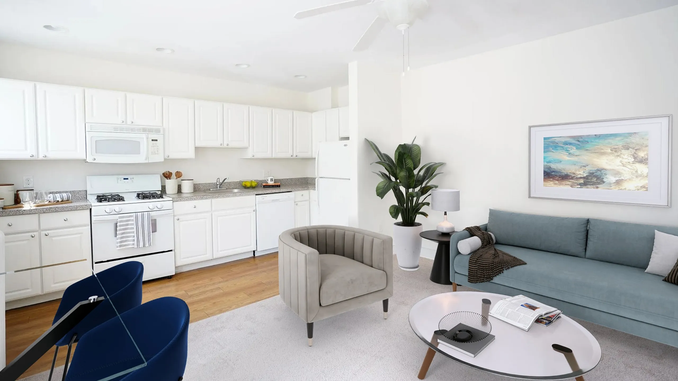 Bright and modern living space with a cozy seating area, elegant coffee table, and spacious kitchen featuring sleek white cabinetry and appliances.