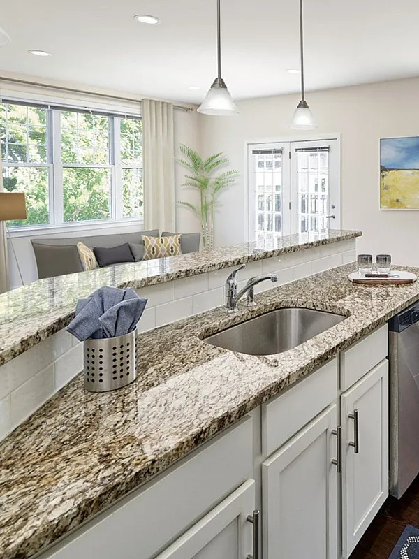 Bright, modern kitchen with granite countertops, sleek appliances, and a cozy dining area, perfect for entertaining.
