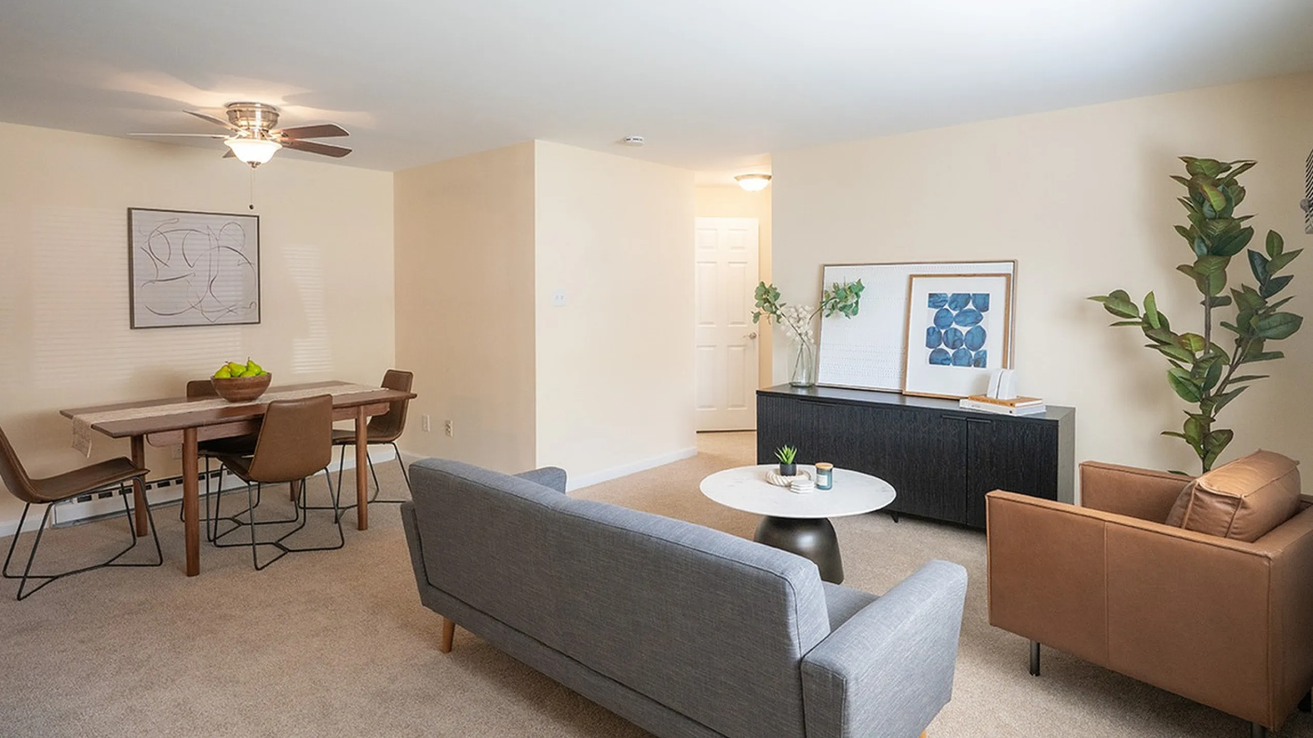 Bright and inviting living area with modern furniture, sleek dining table, and stylish decor, perfect for cozy gatherings.