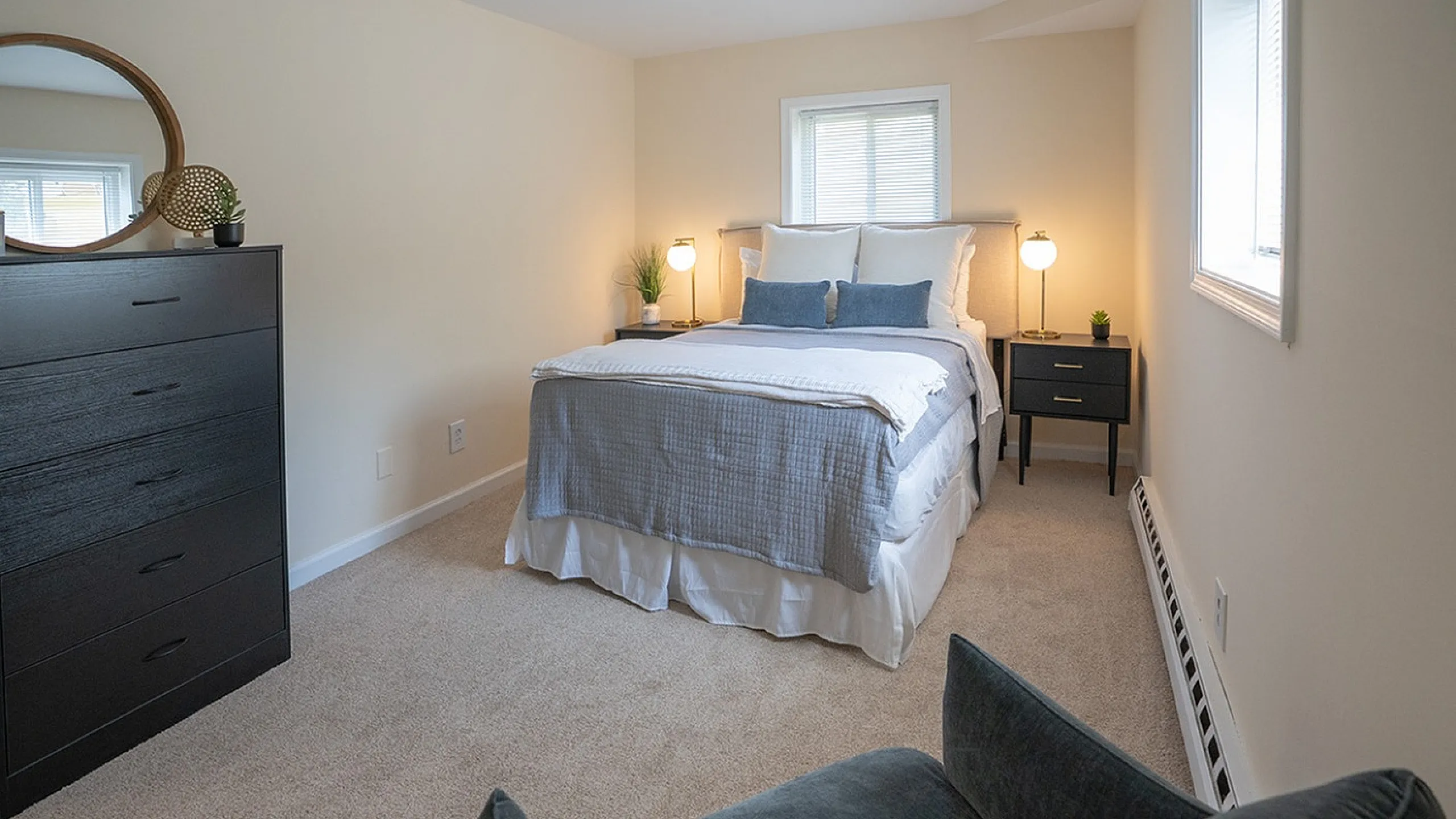 Inviting bedroom with a plush bed, elegant decor, and abundant natural light, creating a cozy and serene atmosphere.