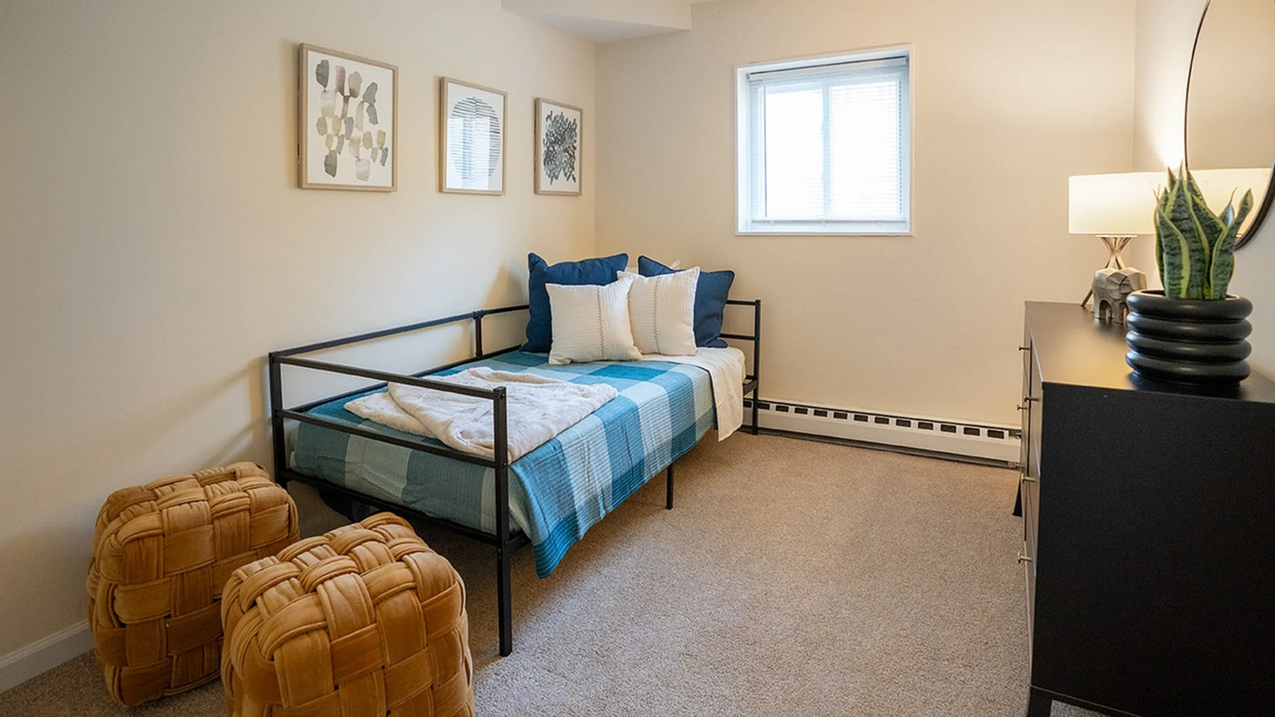 Cozy bedroom with a daybed, stylish decor, and soft lighting creating a warm, inviting atmosphere.