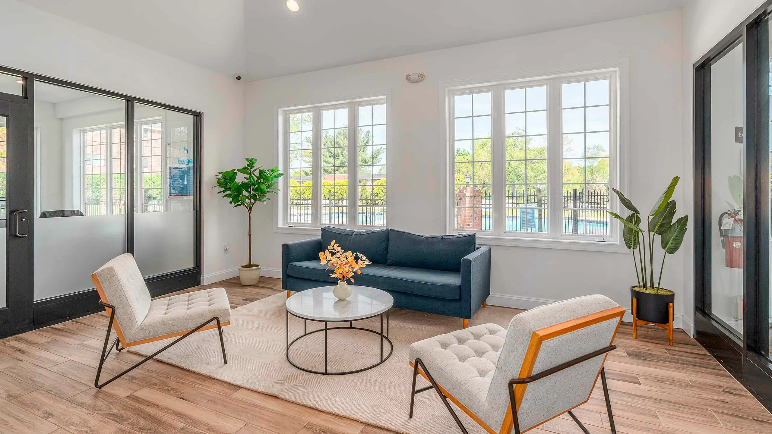 Bright, modern living room with large windows, contemporary furniture, and elegant decor, perfect for relaxing and entertaining.