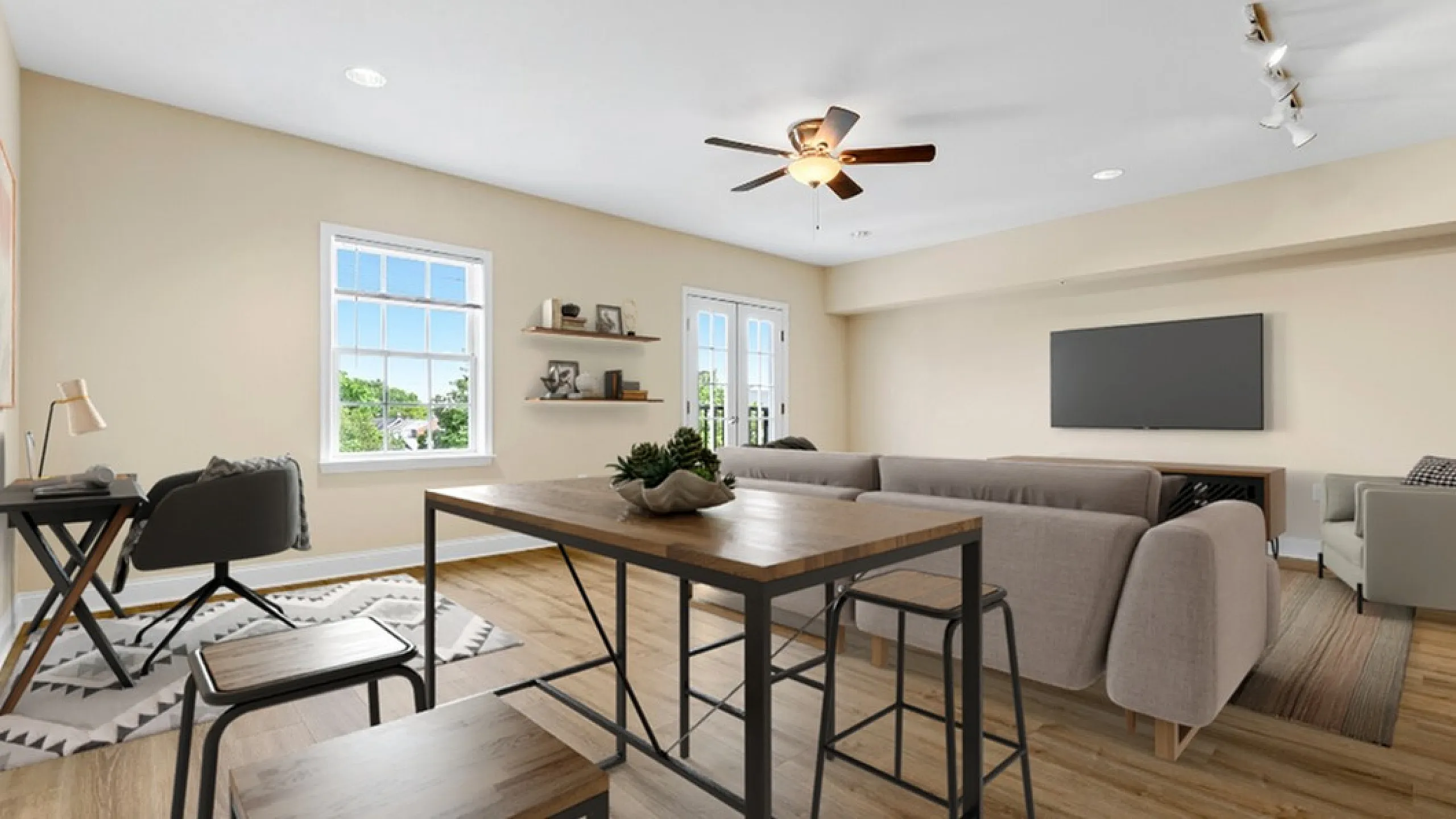 Bright and inviting open-concept living space with natural light, featuring a cozy corner seating area, elegant dining set, and modern workspace.