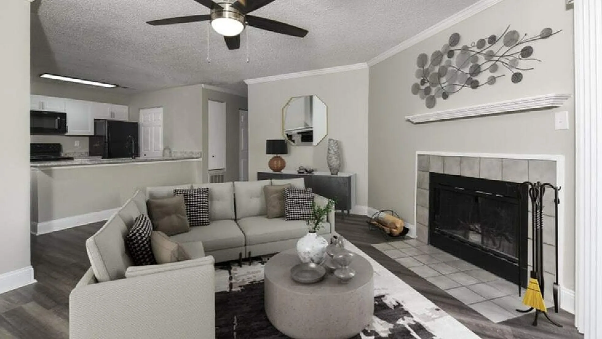 Chic open living room with stylish decor, cozy fireplace, and modern kitchen in the background, perfect for relaxing and entertaining.
