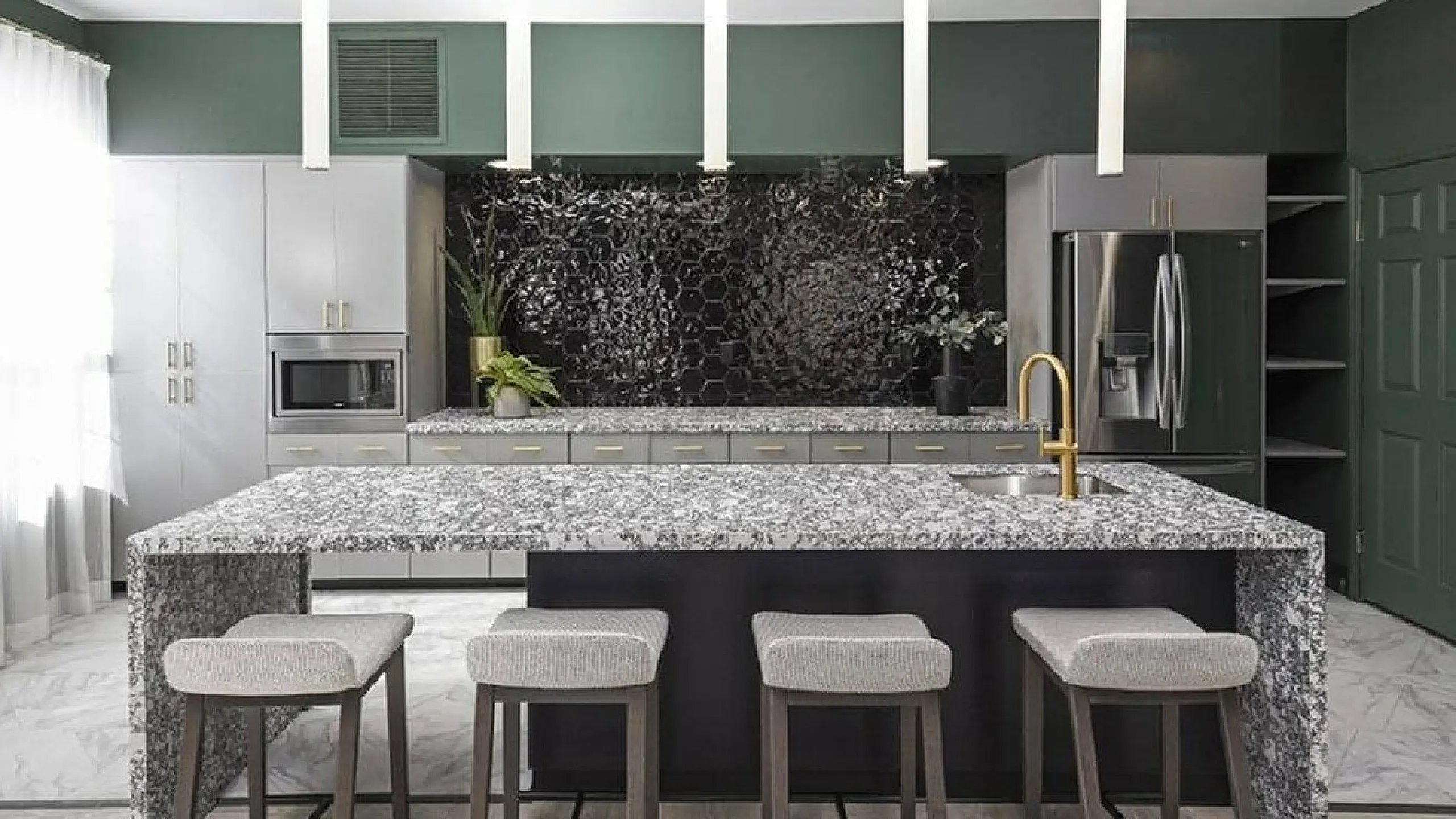 Elegant modern kitchen with granite island, sleek appliances, and stylish pendant lighting, perfect for entertaining.