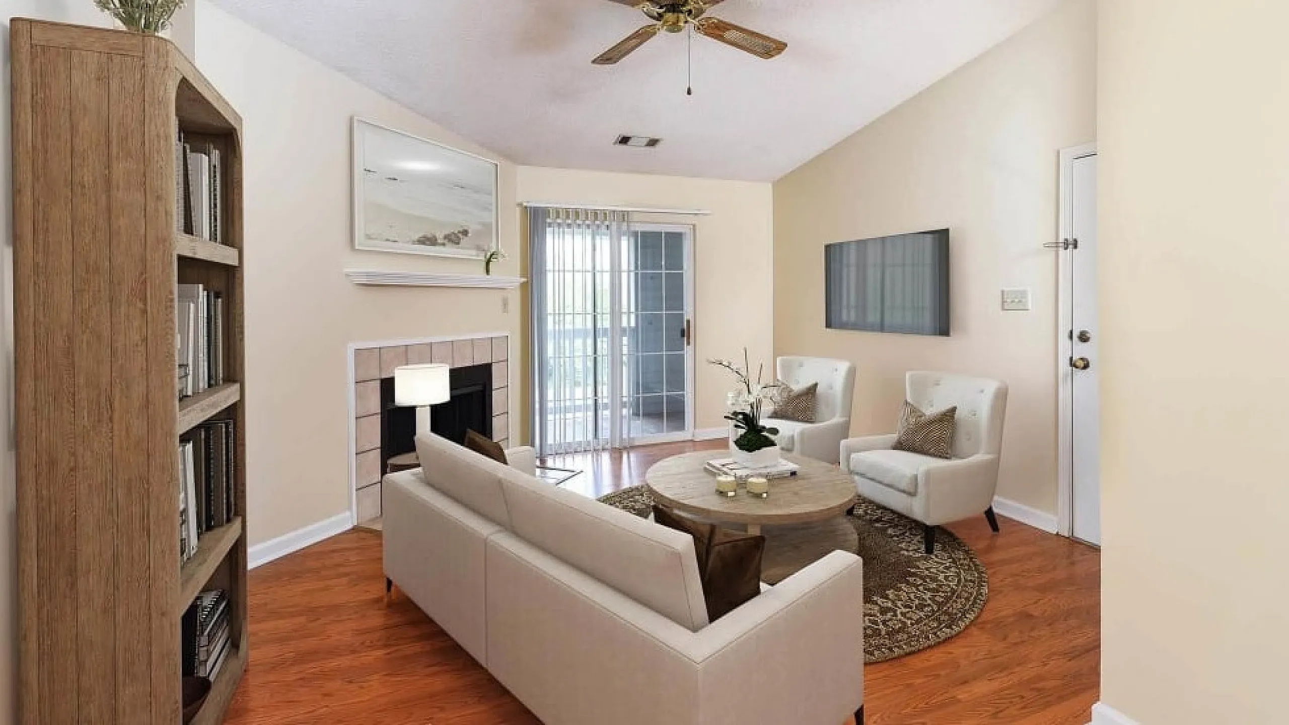 Inviting living room with elegant wood flooring, cozy fireplace, and modern decor, perfect for relaxation and entertaining.