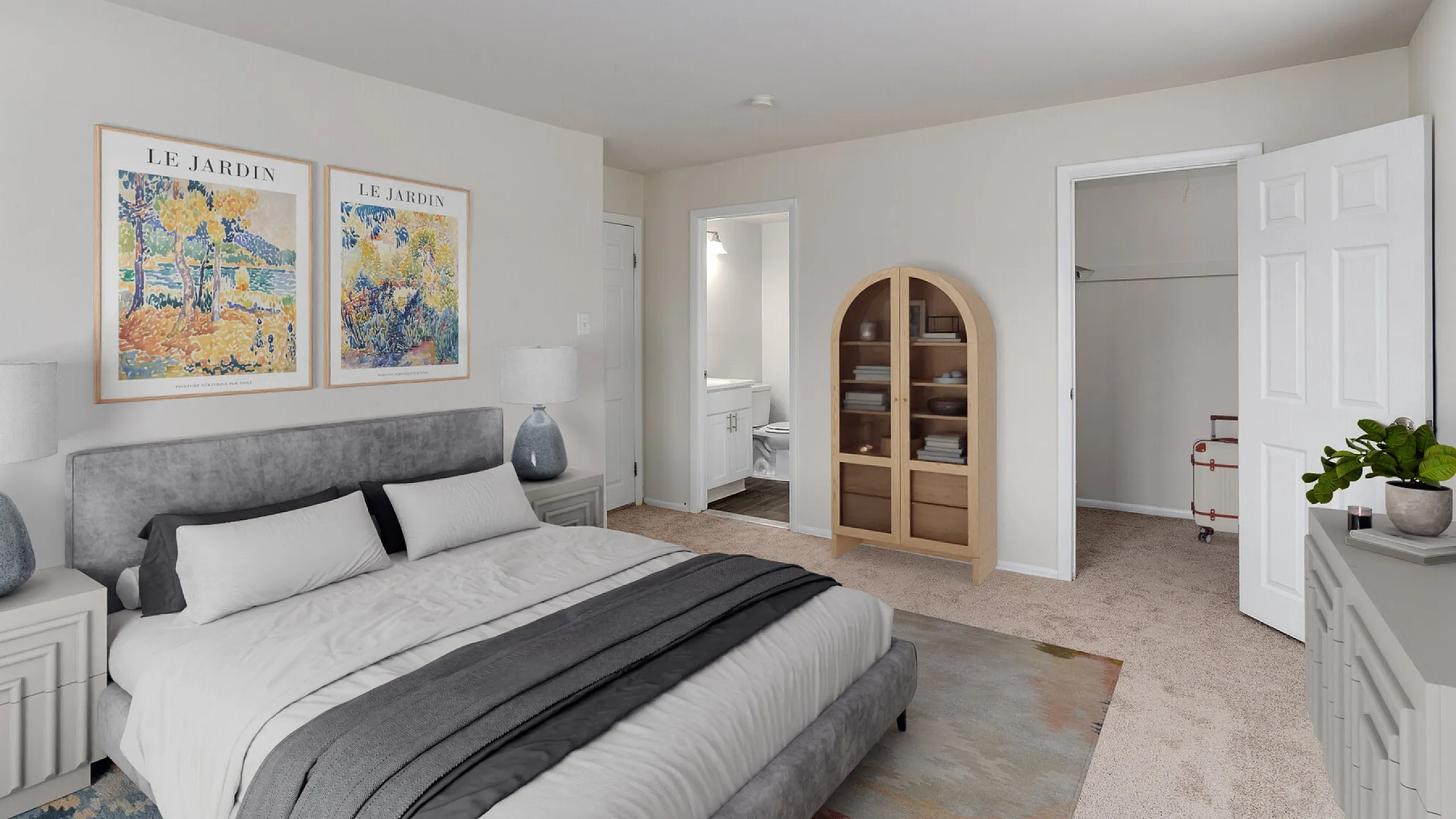 Inviting bedroom with elegant decor, featuring a plush bed, stylish nightstands, and vibrant artwork, leading to a spacious walk-in closet and modern ensuite.