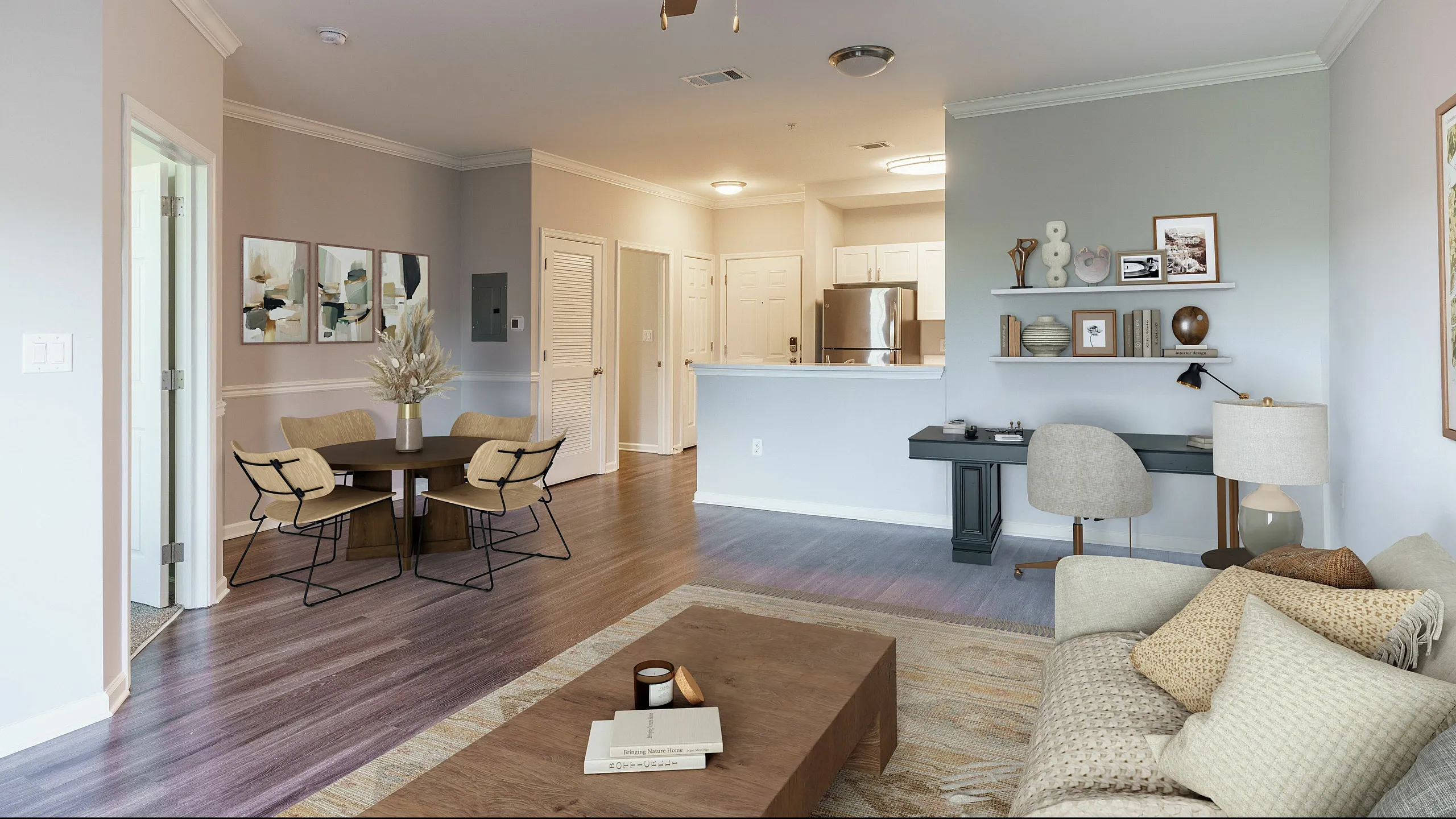Inviting open-concept living room with modern decor, cozy seating, chic dining area, and sleek kitchen.