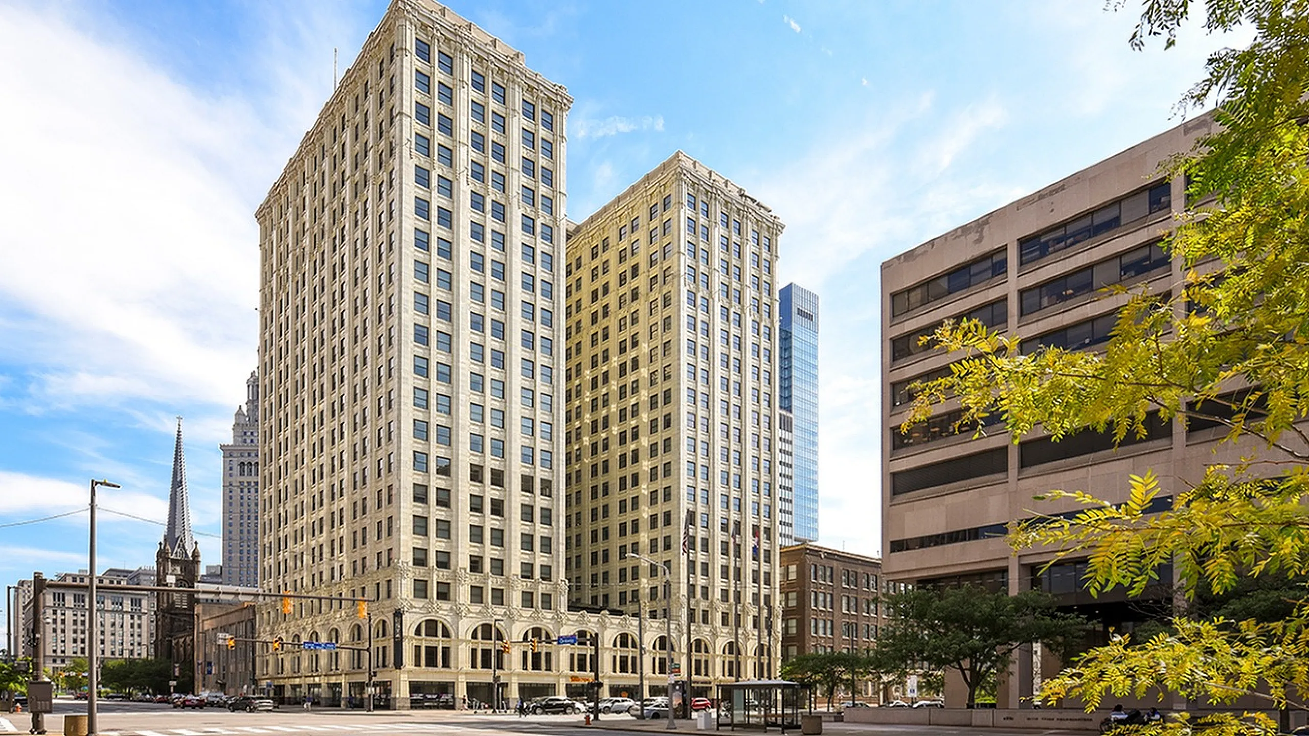 Elegant urban skyline featuring historic high-rise architecture with a bright, inviting setting.